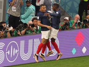 France's Kylian Mbappe celebrates scoring their third goal with Ousmane Dembele.