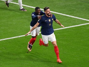 Olivier Giroud of France celebrates with Ousmane Dembele scoring their team's second goal against Australia.