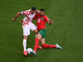 Dejan Lovren of Croatia and Abdelhamid Sabiri of Morocco compete for the ball during the FIFA World Cup Qatar 2022 Group F match.