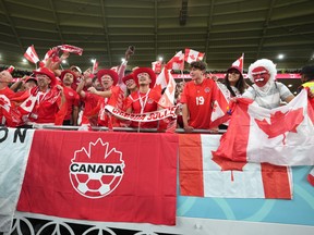 Canada fans cheer as the team arrives on the field to warm up ahead of Group F World Cup soccer action against Belgium at Ahmad bin Ali Stadium in Al Rayyan, Qatar, Wednesday, Nov. 23, 2022. The Mounties are at the World Cup, thanks to Canadians Geoff, Graham and Stephen Rawlinson. THE CANADIAN PRESS/Nathan Denette