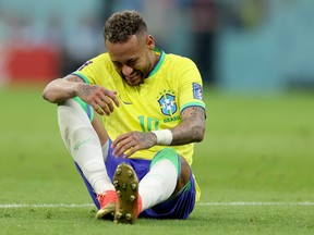 Neymar of Brazil sits injured on the pitch  during the FIFA World Cup Qatar 2022 Group G match against Serbia.