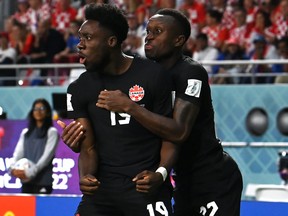 Alphonso Davies of Canada celebrates with teammates after scoring their team's first goal against Croatia.