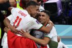 Morocco's Achraf Hakimi (R) and Abdelhamid Sabiri are greeted at the end of the Qatar 2022 World Cup Group F football match between Belgium and Morocco.