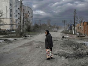 An old woman walks in the Kherson region village of Arkhanhelske on Nov. 3, 2022, which was formerly occupied by Russian forces.