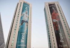 Banners depicting England's captain Harry Kane (L) and the Netherlands' captain Virgil van Dijk displayed on buildings in Doha on November 13, 2022 ahead of the Qatar 2022 World Cup football tournament. (Photo by Paul ELLIS / AFP)