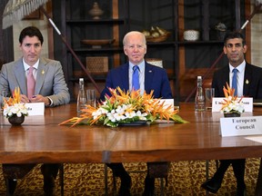 U.S. President Joe Biden (centre), Britain Prime Minister Rishi Sunak (right) and Canada's Prime Minister Justin Trudeau gather to hold an "emergency" meeting to discuss a missile strike on Polish territory near the border with Ukraine, on the side line of the G20 leaders' summit in Nusa Dua, on the Indonesian resort island of Bali on Nov. 16, 2022.