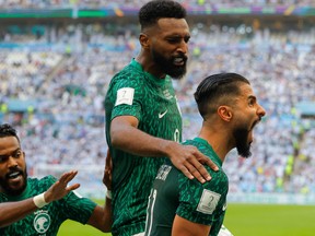 Saudi Arabia's forward #11 Saleh Al-Shehri celebrates after scoring his team's first goal during the Qatar 2022 World Cup Group C football match between Argentina and Saudi Arabia at the Lusail Stadium in Lusail, north of Doha on November 22, 2022. (Photo by Odd ANDERSEN / AFP)