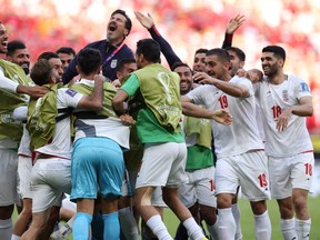 Iran celebrates scoring their first goal during the Qatar 2022 World Cup Group B football match with Wales at the Ahmad Bin Ali Stadium in Al-Rayyan, west of Doha on November 25, 2022.