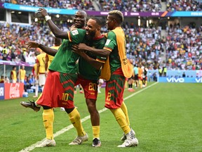 Cameroon's forward #10 Vincent Aboubakar celebrates with Cameroon's forward #20 Bryan Mbeumo and Cameroon's forward #02 Jerome Ngom Mbekeli after scoring his team's second goal during the Qatar 2022 World Cup Group G football match between Cameroon and Serbia at the Al-Janoub Stadium in Al-Wakrah, south of Doha on November 28, 2022.