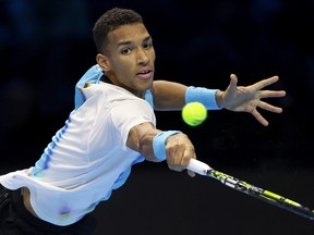 Felix Auger-Aliassime lunges for a ball while playing Casper Ruud during Day One of the Nitto ATP Finals at Pala Alpitour on November 13, 2022 in Turin, Italy.