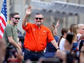 State senator Ted Cruz (orange) waves to the crowd during the Houston Astros Championship Parade in Houston.