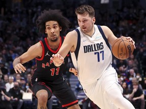 January 19, 2022; Dallas, TX, USA; Dallas Mavericks goaltender Luka Doncic (77) heads for the basket as Toronto Raptors forward Justin Champagnie (11) defends during the second quarter at American Airlines Center.