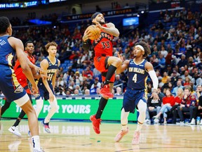 Raptors' Gary Trent Jr. shoots the ball against New Orleans Pelicans Devonte' Graham during the first quarter at Smoothie King Center on Wednesday, Nov. 30, 2022.