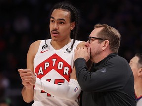 Head coach Nick Nurse of the Toronto Raptors talks to Dalano Banton during a game against the Detroit Pistons.