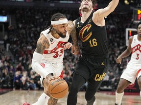 Toronto Raptors guard Gary Trent Jr. (33) drives against Cleveland Cavaliers forward Cedi Osman (16) during the second half at Scotiabank Arena.