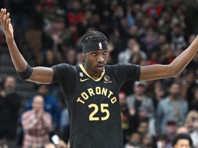 Toronto Raptors forward Chris Boucher (25) gestures to the crowd after scoring a basket against the Dallas Mavericks in the second half at Scotiabank Arena.