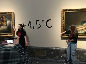Climate protesters from Extinction Rebellion stick themselves to Goya's paintings "La Maja Desnuda" (The Naked Maja) and "La Maja Vestida" (The Clothed Maja) to alert about the climate emergency in Madrid, Nov. 5, 2022 in this picture obtained from social media.