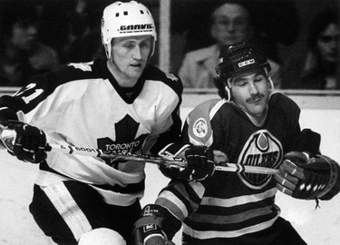 Maple Leaf defenceman Borje Salming (L) hooks Oiler forward Glen Anderson (R) as he keeps him from getting to the puck during first period action here in Toronto on Tuesday, May 3, 1983. THE CANADIAN PRESS/UPC/Gary Hershorn