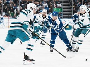 Maple Leafs' Auston Matthews tries to bring the puck through the San Jose Sharks defence during the second period in Toronto on Wednesday, Nov. 30, 2022.