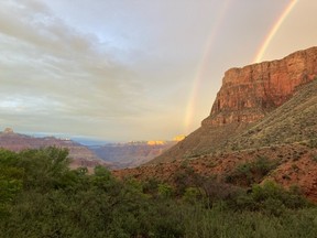 This August 2022 photo provided by the National Park Service shows a double rainbow from the ranger station porch at Indian Garden, which is now called Havasupai Gardens, in Grand Canyon National Park.