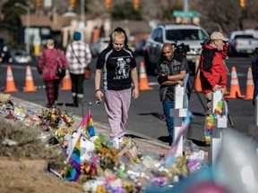 Mourners visit a memorial outside of Club Q in Colorado Springs, Colo., Tuesday, Nov. 22, 2022.