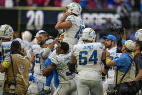 Los Angeles Chargers placekicker Cameron Dicker is lifted by his teammates after kicking the game winning field goal against the Atlanta Falcons during the second half at Mercedes-Benz Stadium. (Dale Zanine-USA TODAY Sports)