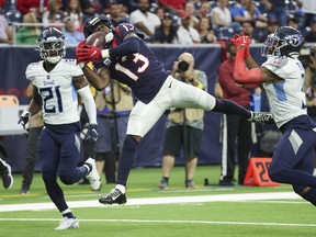 Oct 30, 2022; Houston, Texas, USA; Houston Texans wide receiver Brandin Cooks (13) makes a reception during the fourth quarter as Tennessee Titans cornerback Roger McCreary (21) defends at NRG Stadium.