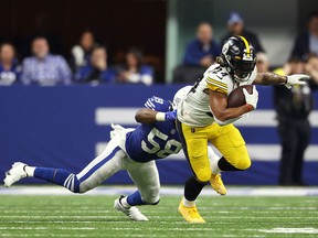 Pittsburgh Steelers running back Benny Snell (24) eludes the tackle of Indianapolis Colts linebacker Bobby Okereke (58) at Lucas Oil Stadium.