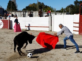 A toreador teacher of the Arles bullfighting school plays with a soccer ball during a bullfight show at the Monumental de Gimeaux arena in Arles, France, November 20, 2022.