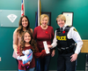 (L) Catherine Denis-Berniqué and her daughter Piper, 8, returned a ring found in her Halloween loot bag to its owner (C) Diane Swanson and the Hawkesbury, Ont. trick-or-treater was given a "positive ticket" from the OPP for her honesty.