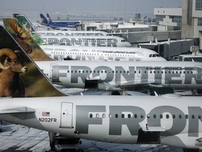 In this Monday, Feb. 22, 2010, file photo, Frontier Airlines jetliners sit stacked up at gates along the A concourse at Denver International Airport.