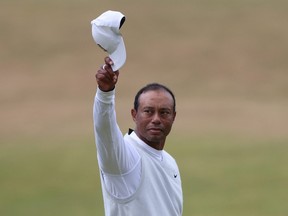Golf - The 150th Open Championship - Old Course, St Andrews, Scotland, Britain - July 15, 2022 Tiger Woods of the US acknowledges the fans after holing on the 18th and finishing his second round REUTERS/Russell Cheyne/File Photo