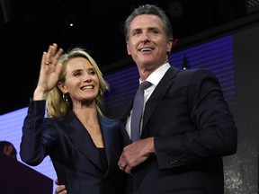 Democratic gubernatorial candidate Gavin Newsom and his wife Jennifer Siebel Newsom wave to supporters during election night event on Nov. 6, 2018 in Los Angeles, Calif.