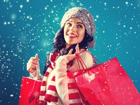 Happy young woman holding shopping bags