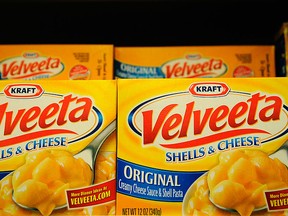 Boxes Velveeta Shells and Cheese sit on a store shelf.