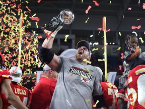 Laurent Duvernay-Tardif of the Kansas City Chiefs raises the Vince Lombardi Trophy after defeating the San Francisco 49ers 31-20 in Super Bowl LIV at Hard Rock Stadium on February 02, 2020 in Miami, Florida.