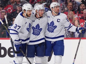 Young Leafs defencemen Timothy Liljegren (left), Rasmus Sandin (middle), help captain  John Tavares celebrate his first-period goal against the New Jersey Devils last nights.