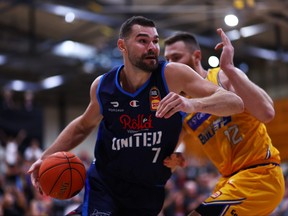 Isaac Humphries of United (L) drives at the basket the NBL Blitz match between Melbourne United and Brisbane Bullets at Darwin Basketball Association on September 23, 2022 in Darwin, Australia.
