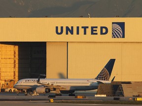 A Boeing 757 jet is parked near a United Airlines hanger before a new day of service. 
 (Photo by David McNew/Getty Images)