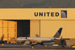 A Boeing 757 jet is parked near a United Airlines hanger before a new day of service. 
 (Photo by David McNew/Getty Images)