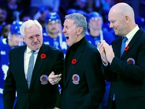 Former Toronto Maple Leafs players and members of the Hockey Hall of Fame, Darryl Sittler, left to right, Borje Salming and Mats Sundin take part in a pregame ceremony prior to a game in Toronto, Friday, Nov. 11, 2022.