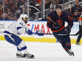 Mar 12, 2022; Edmonton, Alberta, CAN; Tampa Bay Lightning forward Pierre-Edouard Bellemare (41) tries to hold up Edmonton Oilers forward Ryan McLeod (71) during the third period at Rogers Place. Perry Nelson-USA TODAY Sports