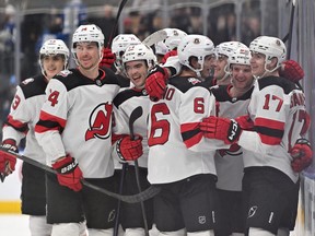New Jersey Devils forward Yegor Sharangovich (17) celebrates with teammates after scoring a goal in overtime against the Toronto Maple Leafs at Scotiabank Arena.