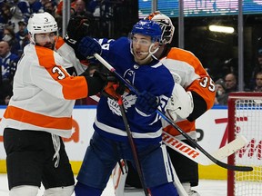 Apr 19, 2022; Toronto, Ontario, CAN; Toronto Maple Leafs forward Michael Bunting (58) and Philadelphia Flyers defenseman Keith Yandle (3) battle for position during the third period at Scotiabank Arena.