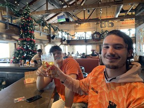 Jaap Jansen Schoonhoven (right) toasts a Netherlands victory with buddy Sil Verouden at Amsterdam BrewHouse on Queen's Quay on Monday, Nov. 21, 2022. The two exchange students watched the 11 a.m. game over some beers.