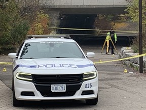 A Peel Regional Police officer is pictured with evidence markers  near Meadowvale Community Centre in Mississauga on Thursday morning, the morning after a  fatal shooting was reported in the area.