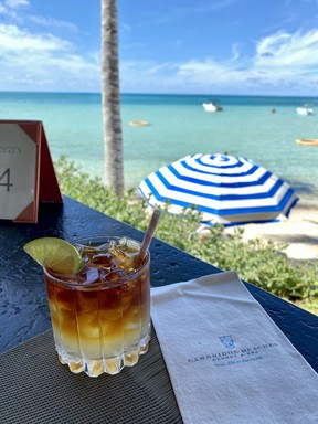 Relax with a Dark ’n’ Stormy cocktail while dining alfresco at Breezes restaurant at Cambridge Beaches in Bermuda. CYNTHIA MCLEOD/TORONTO SUN