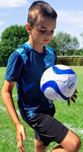 Ibrahim Odza, 13, playing soccer pre-surgery.