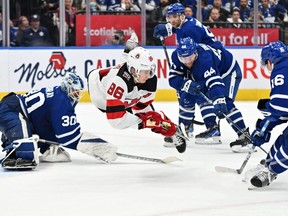 Devils forward Jack Hughes (86) falls after being tripped by Toronto Maple Leafs goalie Matt Murray (30) while passing the puck to a teammate to score a goal in overtime at Scotiabank Arena on Wednesday night.  Mandatory Credit: Dan Hamilton-USA TODAY Sports