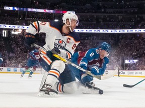 Edmonton Oilers captain Connor McDavid carries the puck in front of Colorado Avalanche star defenceman Cale Makar during the NHL playoffs last season.